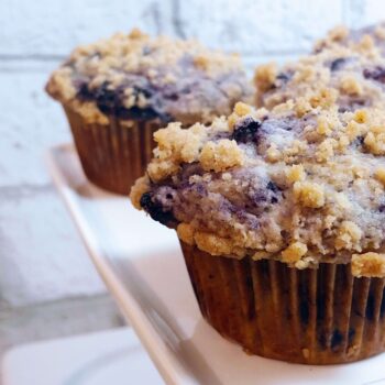 cooked blueberry streusel muffins on a serving tray