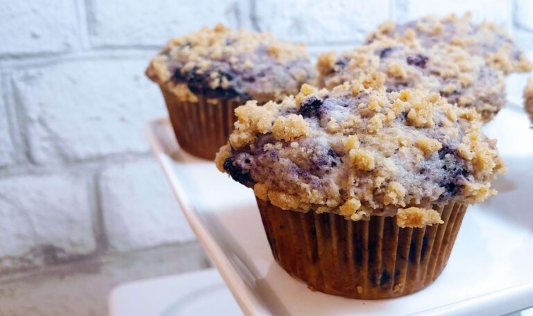 cooked blueberry streusel muffins on a serving tray