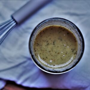 close up image looking down into honey dijon salad dressing in a mason jar