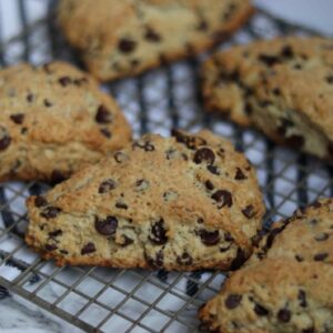 close up image of chocolate chip scones on a wire cooling rack