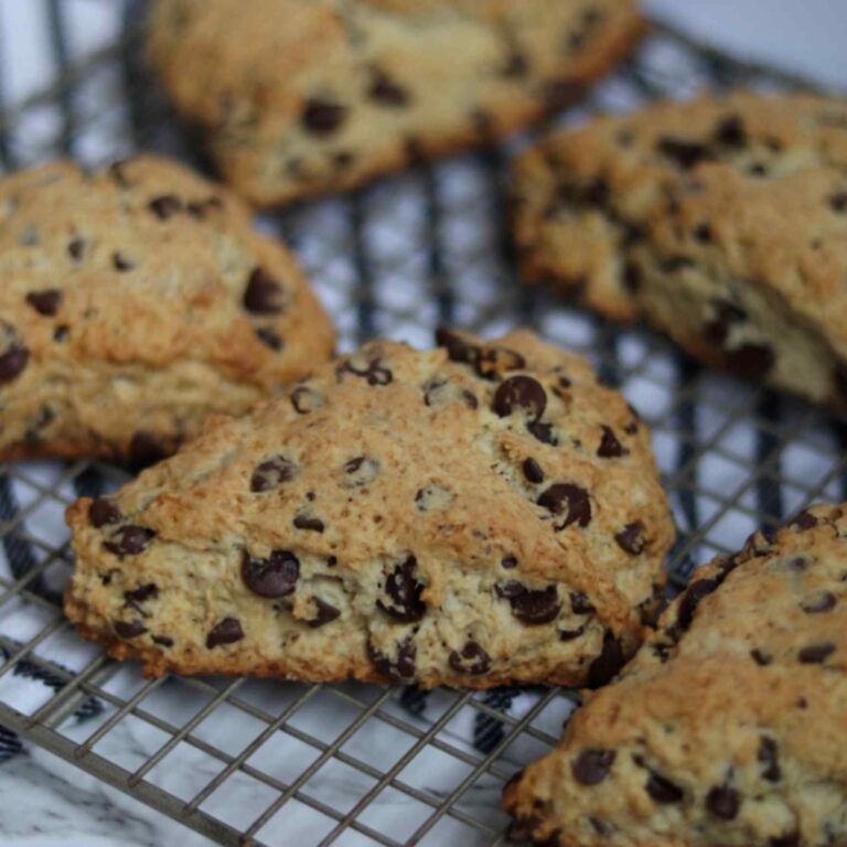 close up image of chocolate chip scones on a wire cooling rack