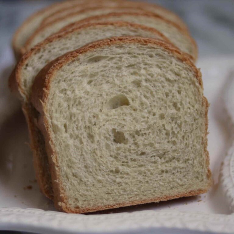 slices of homemade sandwich bread on a white serving tray