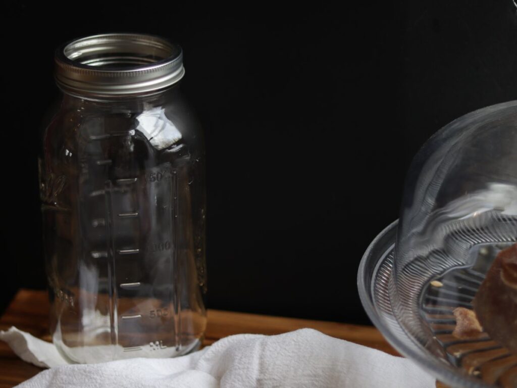 large wide mouth glass mason jar on a wooden cutting board