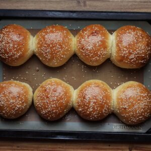 homemade hamburger buns on a baking sheet