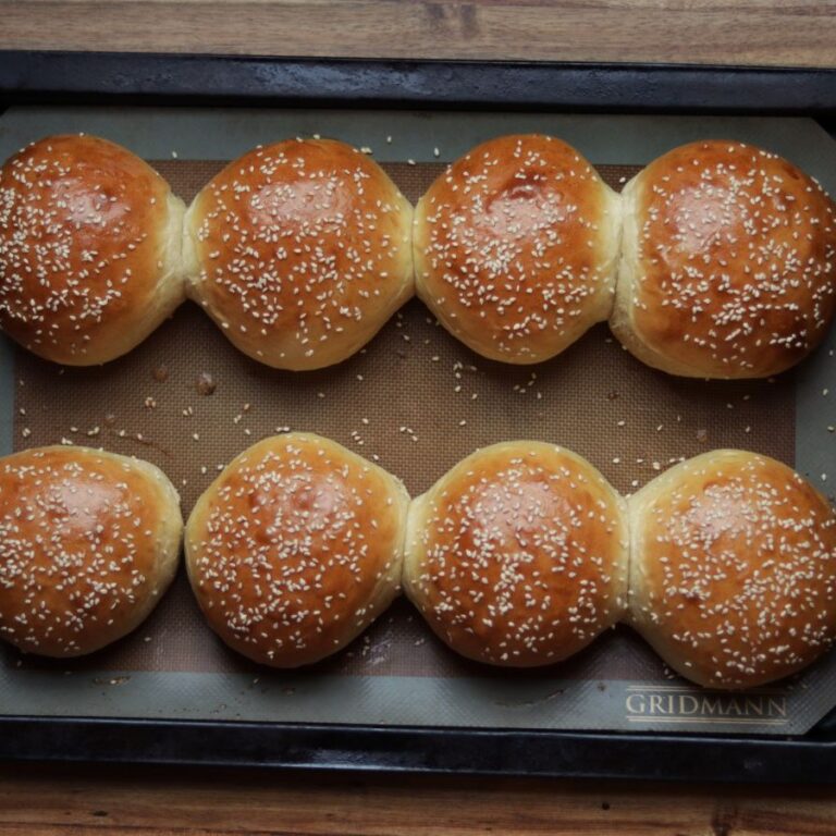 homemade hamburger buns on a baking sheet